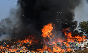 Pakistani Customs officials burn to destroy smuggled goods (Cigarettes, Chew Tobacco, Betel Nuts, Fireworks and others things near Wagha Border on the eve of world customs day in Lahore.  A Pile of confiscated drugs, cigarettes and others goods which were seized from different areas, during ceremony for launching awareness campaigns across the province, organized by Pakistan Customs held at Wagha Border in Lahore