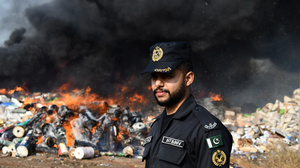 Pakistani Customs officials burn to destroy smuggled goods (Cigarettes, Chew Tobacco, Betel Nuts, Fireworks and others things near Wagha Border on the eve of world customs day in Lahore.  A Pile of confiscated drugs, cigarettes and others goods which were seized from different areas, during ceremony for launching awareness campaigns across the province, organized by Pakistan Customs held at Wagha Border in Lahore