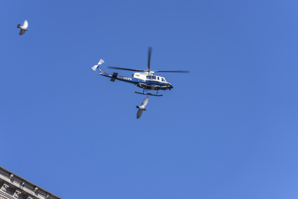 Police helicopter flying overhead during transfer of remains of fallen police officer Wilbert Mora to Riverdale Funeral Home. Officer Mora was critically injured, and died of his injuries on January 25, after responding to a domestic violence call on January 21 with his partners, where one of them, Jason Rivera was shot and killed. Perpetrator was also injured in the shootout and died as well later on at the hospital.