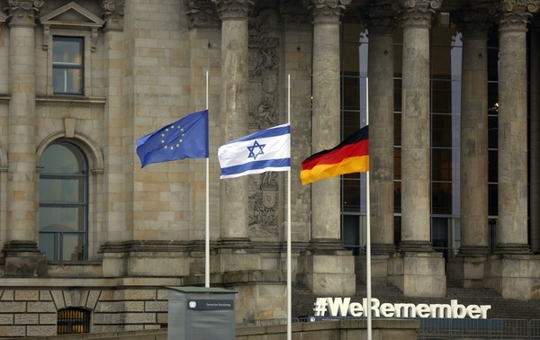 This year, the German Bundestag is participating in the "#WeRemember" campaign on the occasion of International Holocaust Remembrance Day on Thursday, January 27, 2022. The photo shows the Reichstag building with flags at half-mast and white letters WeRemember.