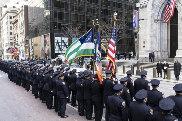 Police officers pay tribute as friends and family members arrive at Saint Patrick's Cathedral at the wake for New York police officer Jason Rivera. Police Officer Jason Rivera was killed by gunman on January 21, 2022 while responding to a domestic dispute call.