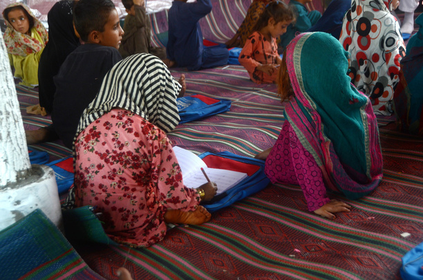 Afghan children were seen learning inside the tent village. Al-Khidmat Foundation (AKF) established a tent village for flood-affected Afghan refugees at Hassan Khel, district Charsadda. The houses of 180 Afghan refugees residing in Hassan Khel an adjacent locality of Sar Daryab were destroyed in the recent flood.