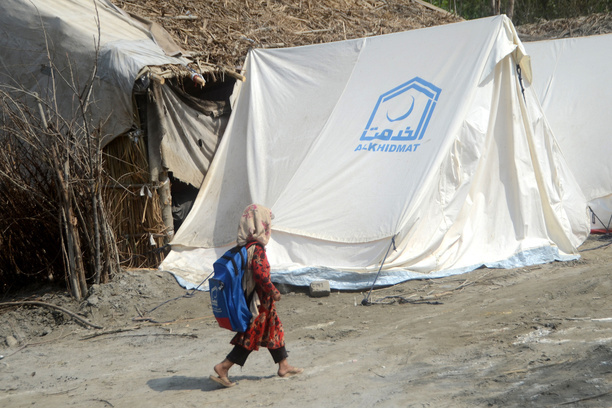 An Afghan child seen going back to her tent, after attending a makeshift school, inside the tent village. Al-Khidmat Foundation (AKF) established a tent village for flood-affected Afghan refugees at Hassan Khel, district Charsadda. The houses of 180 Afghan refugees residing in Hassan Khel an adjacent locality of Sar Daryab were destroyed in the recent flood.