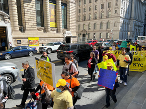 Demonstrators are holding pro-vendor rights signs in Lower-Manhattan, New York City to demand better laws and treatment for street vendors.
