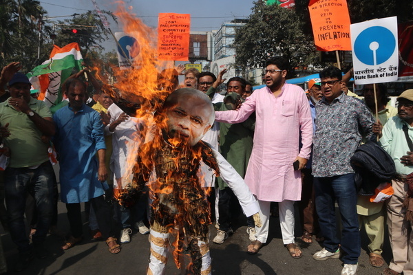 An activists of the youth wing of the Congress burns effigy of Prime Minister Narendra Modi and Adani Group Chief Goutatam Adani during a protest against alleged investments by LIC and SBI in Adani Group in Kolkata. New York-based investor research firm Hindenburg Research accused industrialist Gautam Adani-led conglomerate of 'brazen stock manipulation and accounting fraud scheme over the course of decades'.
