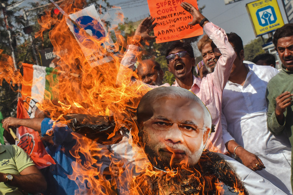 Indian National Congress supporters burning an effigy of Gautam Adani and Narendra Modi, protest against Adani group's scam and Union Budget.