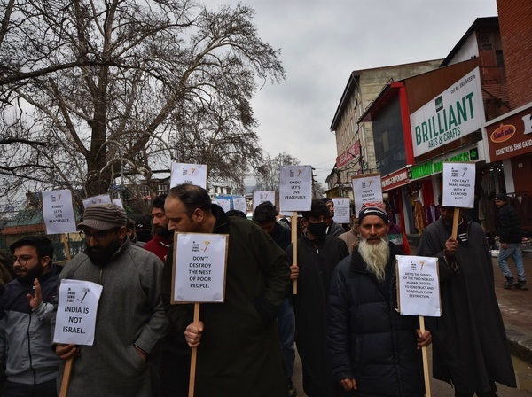 Members of different political parties holding placards and shouting slogans during the protest against the Administration on demolition and encroachment drive by authorities in all districts of Jammu and Kashmir.