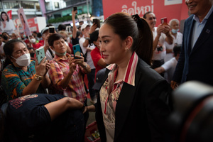 Paethongtarn Shinawatra (C), Chairman of the Engagement and Innovation Advisory Board of The Pheu Thai Party, Help Pheu Thai Party's candidate for the House of Representatives, during a campaign at Stadium one, Banthadthong Road, Pathum Wan district, Bangkok, Thailand, on March 24, 2023.