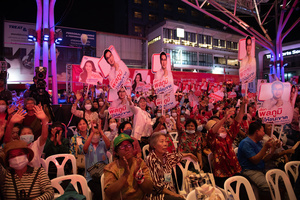 supporters, holding a face sign Pheu Thai Party's candidate for the House of Representatives, during a campaign rally at Stadium one, Banthadthong Road, Pathum Wan district, Bangkok, Thailand, on March 24, 2023.