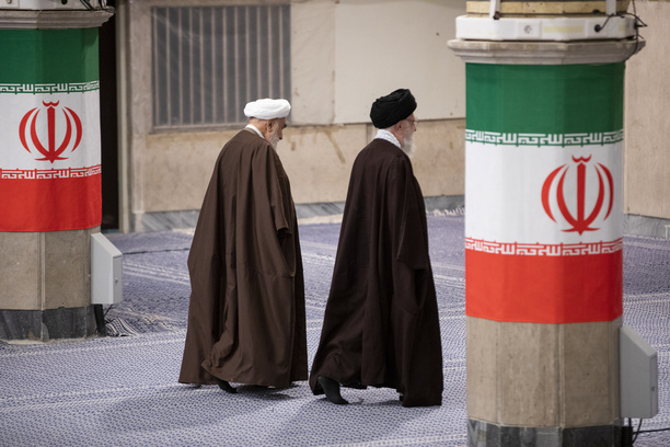 Iran's supreme leader Ayatollah Ali Khamenei walks past Iranian flags after casting his votes in the parliamentary elections and the elections for the Council of Experts on 01 March 2024, Iran, Tehran.