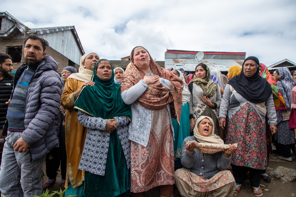 Family members of the missing persons mourn as Rescuers of the National Disaster Response Force (NDRF) search after a boat carrying people, including children, capsized in the Jhelum River in the outskirts of Srinagar. At least six people died and 19 were missing after the boat capsized in the Jhelum River near Srinagar, with most of the passengers were children on their way to school.
