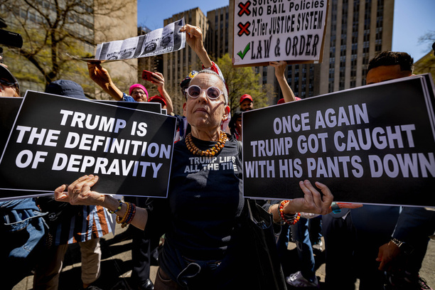 An anti-Trump activist is surrounded by supporters of former U.S. President Donald Trump outside the Manhattan Criminal Court on the first day of his hush money trial. Trump is in court for a high-stakes hearing charged by Manhattan District Attorney Alvin Bragg with 34 counts of falsifying business records to disguise hush money payments to a porn star before the 2016 election. 