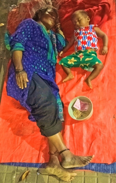 On Eid-ul-fitr day a street mother, sleeping with her son at Indira road Dhansiri apartment street in Dhaka. Eid brings no happiness for them. As they are begging on street but getting low income because of empty street of Eid day. Due to a negative income shock of 25 per cent people in the country, the overall poverty rate will rise to 40.9 per cent.
