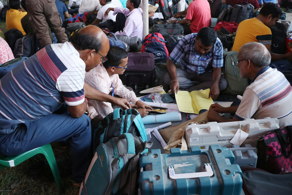 Polling officials after checks Electronic Voting Machine (EVM) and other documents at a distribution centre and goes to the polling station in Coochbehar ahead of the first Phase the Lok Sabha general election in West Bengal in India on April 18,2024.