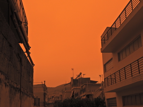 A large cloud of African Dust is seen covering the sky of Athens making the sky appear orange.