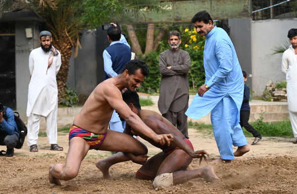 1. RAWALPINDI, PAKISTAN, APRIL 26: Pakistani traditional wrestlers compete to win the competition during the annual tradition wrestling which usuallly takes place annually to welcome the Spring season at a nearly century old wrestling arena locally known as Akhara in Rawalpindi, Pakistan, on April 26, 2024. In the competition organized by senior wrestlers, the wrestlers try to overcome their opponents. Pehlwani or Kushti, is a form of wrestling contested in the South Asia. Training for this sport is difficult and requires a routine. A wrestler’s day begins with exercise and ends with exercise.

2. RAWALPINDI, PAKISTAN, APRIL 26: Pakistani spectators watch as the traditional wrestlers compete to win the competition during the annual tradition wrestling which usuallly takes place annually to welcome the Spring season at a nearly century old wrestling arena locally known as Akhara in Rawalpindi, Pakistan, on April 26, 2024. In the competition organized by senior wrestlers, the wrestlers try to overcome their opponents. Pehlwani or Kushti, is a form of wrestling contested in the South Asia. Training for this sport is difficult and requires a routine. A wrestler’s day begins with exercise and ends with exercise

3. RAWALPINDI, PAKISTAN, APRIL 26: Pakistani traditional wrestlers dance over the beat of drums prior the start of competition during the annual tradition wrestling which usuallly takes place annually to welcome the Spring season at a nearly century old wrestling arena locally known as Akhara in Rawalpindi, Pakistan, on April 26, 2024. In the competition organized by senior wrestlers, the wrestlers try to overcome their opponents. Pehlwani or Kushti, is a form of wrestling contested in the South Asia. Training for this sport is difficult and requires a routine. A wrestler’s day begins with exercise and ends with exercise