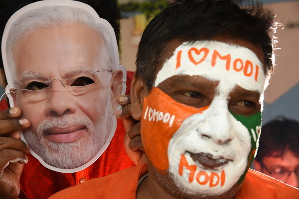 Indian Hair Artist Robin Das makes a body painting on the face of a BJP Supporter before joining the bjp party rally ahead the Lok Sabha General Election camping in Near Kolkata on May 01,2024.
