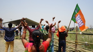 Bharatiya Janata Party (BJP) supporters listening to Indian Prime Minister Narendra Modi helicopter landing near the meeting area during a public rally ahead of the third phase of the General Elections in Burdwan South District,West Bengal.