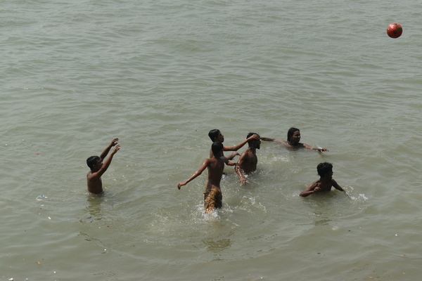 People are bathing on the Ganges river on a hot summer day in Kolkata.
