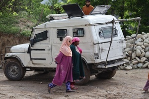 Women walk past armoured vehicle outside the polling station in Tral area of Pulwama district during Lok Sabha Srinagar Parliamentary Constituency election on Monday 13 May. This is the first major election being held in Jammu and Kashmir after the abrogation of Article 370 and the bifurcation of the erstwhile state into two union territories of Jammu and Kashmir and Ladakh in 2019.
