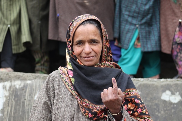 A woman shows her ink-marked finger after casting a vote at Karmulla area of Sub-district Tral, in Lok Sabha Srinagar Parliamentary Constituency election on Monday 13 May. This is the first major election being held in Jammu and Kashmir after the abrogation of Article 370 and the bifurcation of the erstwhile state into two union territories of Jammu and Kashmir and Ladakh in 2019.
