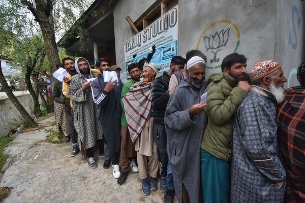 Men queue up to cast their ballots at a polling station during the fourth phase of voting in India's general election, in Ganderbal on May 13, 2024.