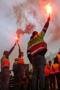Avilés, Spain, May 16, 2024: Several workers with flares during the Demonstration for the future of Saint Gobain, on May 16, 2024, in Avilés, Spain.