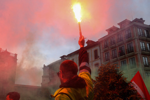 Avilés, Spain, May 16, 2024: A worker with a flare during the Demonstration for the future of Saint Gobain, on May 16, 2024, in Avilés, Spain.