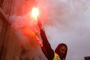 Avilés, Spain, May 16, 2024: A worker with a flare during the Demonstration for the future of Saint Gobain, on May 16, 2024, in Avilés, Spain.