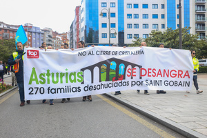 Avilés, Spain, May 16, 2024: One of the banners of the demonstration with "No to the closure of glassworks, Asturias is bleeding, 270 families evicted by Saint Gobain" during the Demonstration for the future of Saint Gobain, on May 16, 2024, in Avilés, Spain.