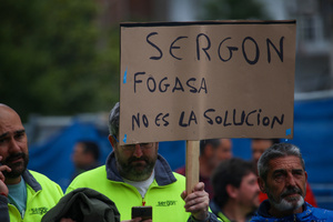 Avilés, Spain, May 16, 2024: A man carries a sign with "Sergon, Fogasa is not the solution" during the Demonstration for the future of Saint Gobain, on May 16, 2024, in Avilés, Spain.
