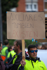 Avilés, Spain, May 16, 2024: A man carries a sign with "Auxiliaries also exist" during the Demonstration for the future of Saint Gobain, on May 16, 2024, in Avilés, Spain.