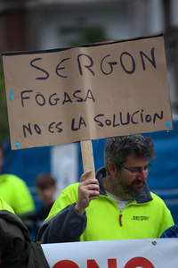 Avilés, Spain, May 16, 2024: A man carries a sign with "Sergon, Fogasa is not the solution" during the Demonstration for the future of Saint Gobain, on May 16, 2024, in Avilés, Spain.