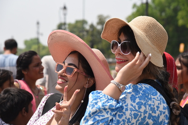 A group of tourists wearing hats to protect themselves from severe heatwave has gripped Delhi and several other parts of north India, May 20, 2024, with the India Meteorological Department (IMD) issuing a ‘red alert’ warning. A ‘red alert’ is issued when extreme weather conditions are a "high health concern" for vulnerable people, including infants, the elderly and those with chronic diseases. Photo by Sondeep Shankar/ Pacific Press