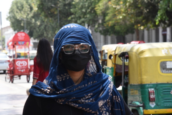 People protect themselves from a severe heatwave has gripped Delhi and several other parts of north India, May 20, 2024, with the India Meteorological Department (IMD) issuing a ‘red alert’ warning. A ‘red alert’ is issued when extreme weather conditions are a "high health concern" for vulnerable people, including infants, the elderly and those with chronic diseases. Photo by Sondeep Shankar/ Pacific Press