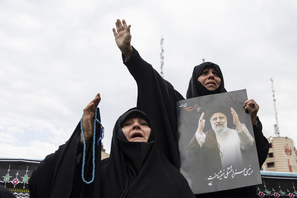 A woman holds up a poster of Iranian President Ebrahim Raisi during a mourning ceremony for him at Vali-e-Asr Square in downtown Tehran, Iran, Monday, May 20, 2024. Iranian President Ebrahim Raisi and the country's foreign minister, Hossein Amirabdollahian, were found dead Monday hours after their helicopter crashed in fog.