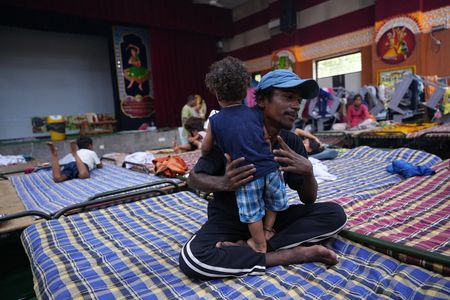 A father playing with his child inside a flood relief camp in a nearby school. People from the low lying areas around the Yamuna River were relocated to camps after the Yamuna River overflowed due to heavy monsoon rainfall.