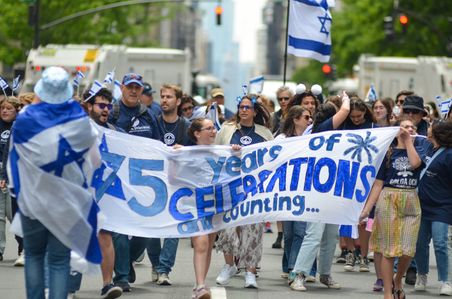 Marchers are seen holding Israeli flags as marchers head up Fifth Avenue, New York City in the annual Salute to Israel Parade on June 4, 2023.