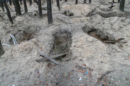 View of hundreds of mass unmarked graves in city of Kupyansk found after city was liberated from Russian forces.