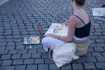 Girl paints in St. Peter's Square in Rome