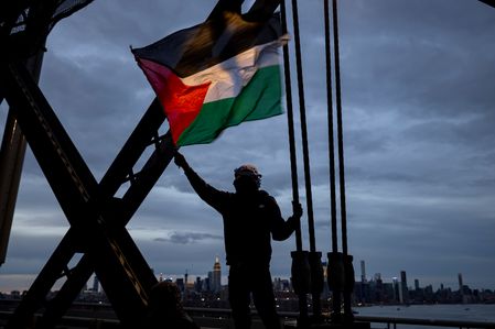 A pro-Palestine protester carries a flag while marching over the Williamsburg Bridge demanding a permanent ceasefire between Israel and Hamas. Israel has launched relentless air and ground attacks in the Gaza Strip following an Oct. 7 Hamas attack, killing more than 15,000 Palestinians, including more than 6,000 children and 4,000 women, according to health authorities in the enclave. Thousands of buildings, including hospitals, mosques and churches, have been damaged or destroyed in Israel’s air and ground attacks on the besieged enclave.