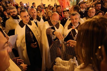 Pagani, Salerno, Italy - April 23,2023 :Exchange of gifts, hens and doves, between the priests of the Basilica of Sant'Alfonso Maria de' Liguori and the Archconfraternity of Madonna delle Galline. Procession through the streets of the city of Madonna del Carmelo, called "Madonna delle Galline". Welcomed by the faithful with the offering of hens, doves, flower petals. In its passage the dances open to the sound of tammorras.