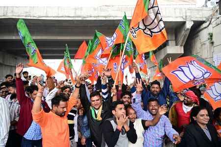 BJP workers celebrate the party's lead in Rajasthan, Madhya Pradesh and Chhattisgarh during the counting of votes of elections for the Legislative Assemblies of the states in Ajmer.