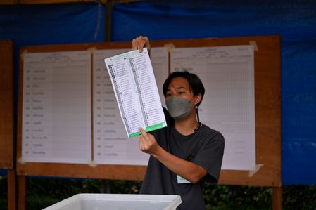 Workers count a votes after polling station close 
on a day of general elections