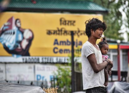 In Srinagar, the summer capital of Indian-administered Kashmir, an Indian migrant from the Indian state of Rajasthan With her baby girl by the side of the road on April 27,2023. Over the past two decades, Kashmir has experienced an unprecedented influx of low-income migrants from various regions of India. Many of them still carry the stigma of untouchability and low caste degradation and live in poverty with limited access to education and sanitary living conditions. Families as a whole, often from the Indian state of Rajasthan, labour to hand-craft brooms out of bamboo and date palms. Indian markets charge $0.37 to $0.46 (20 to 25 INR) for a broom, and a family's daily income ranges from $1.47 to $1.84 (80 to 100 INR). Even though the Indian economy has experienced significant growth, millions of people continue to make do on less than $1 (50 INR) per day.