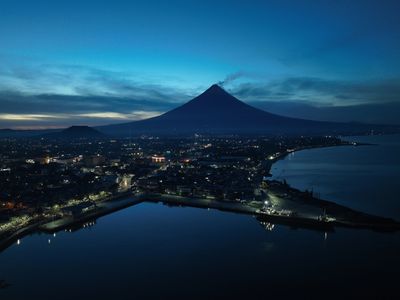Sunset at Mt. Mayon volcano on June 13, 2023 in Legaspi City, Philippines. Around 15,000 people have left their homes which is within the 6-kilometer (3.7-mile) danger zone radius of Mayon since volcanic activity lava flow, ash fall and sulfuric gas emission increased since last week.