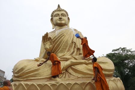 Buddhist monk climbs a giant statue of Buddha, to wash and decorate for the upcoming Buddha Purnima near Kolkata City. Buddha Purnima celebrates on May 5.