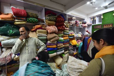 People checks clothes at a Anjum Gulfam's shop at Buhrikadal in Srinagar the Summer captial of Indian Administrated Kashmir on May, 05, 2023.

Meet "Anjum Gulfam" a successful entrepreneur from Buhrikadal downtown Srinagar the Summer captial of Indian Administrated.
She is first lady garment dealer with a unique marketing gimmick.
A first of it's kind - A shop owned by this Lady, in downtown area of Srinagar, where all kinds of garments for sale in Kilograms.she made a successful business and has given employment to 20 people.