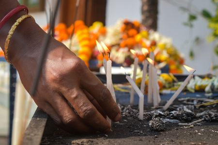 A woman is putting candles inside a church on the occasion of Christmas on the outskirts of Kolkata.