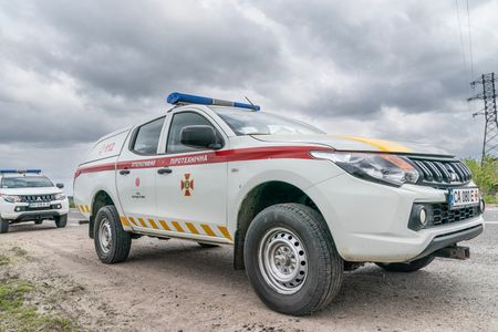 Vehicles donated by Japan used by sappers to clear land from possible landmines before workers fix electric power transmission line destroyed during Russian invasion near village of Kamyanka of Kharkiv Region of Ukraine